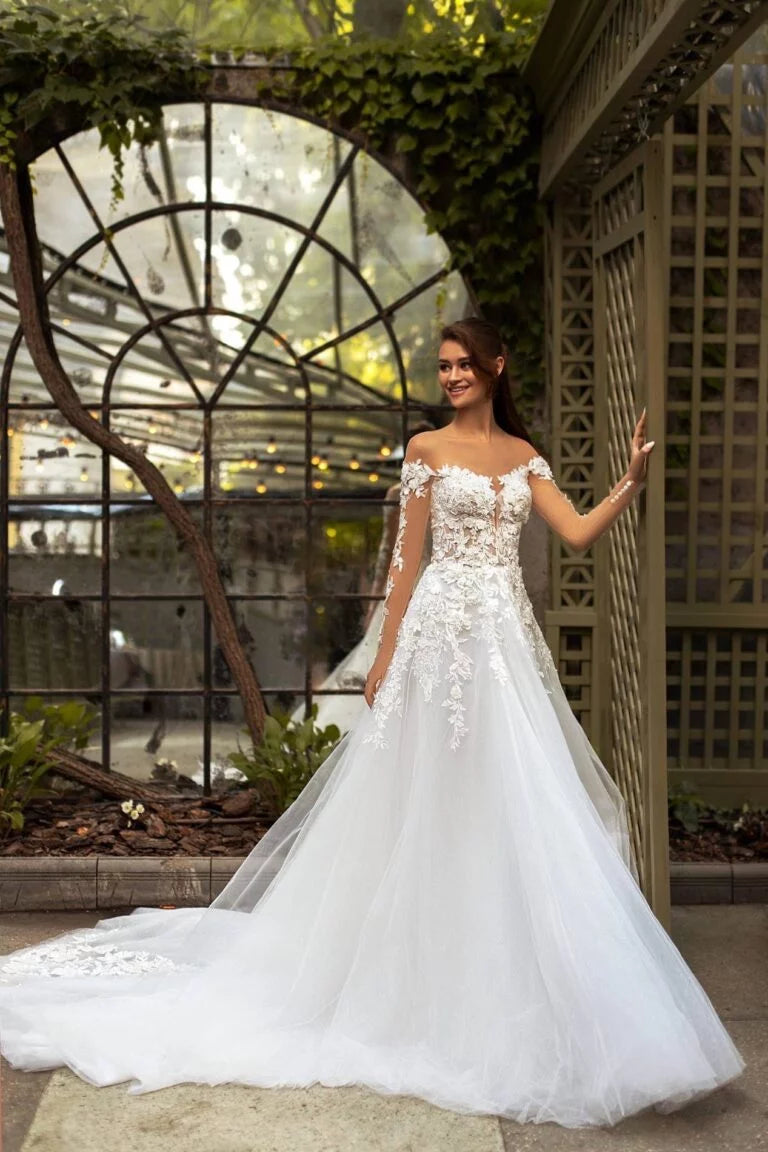 Elegant A-Line Wedding Gown with Off-Shoulder Neckline, Long Sleeves, and a Graceful Dropped Waist for a Breathtaking Bridal Look