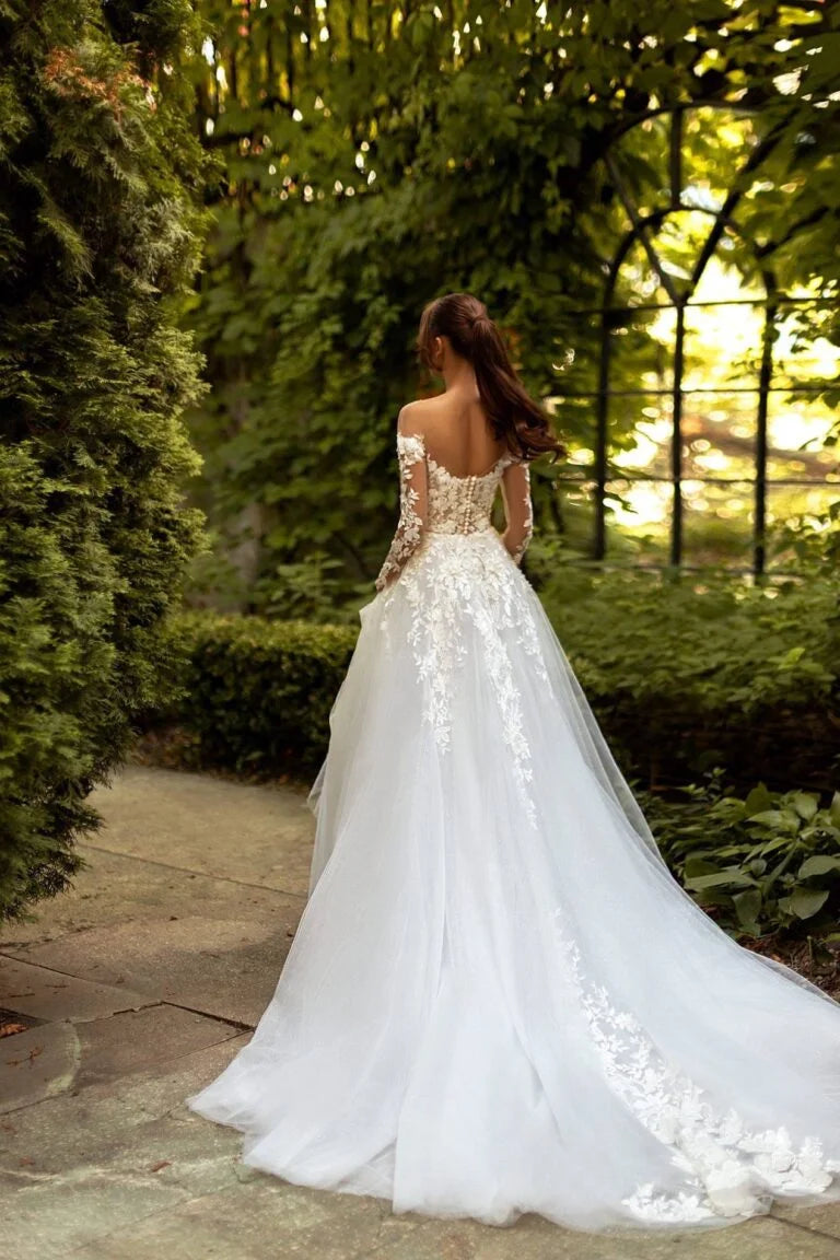 Elegant A-Line Wedding Gown with Off-Shoulder Neckline, Long Sleeves, and a Graceful Dropped Waist for a Breathtaking Bridal Look