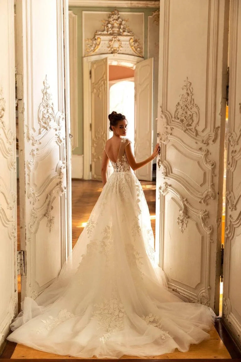 Romantic A-Line Wedding Gown with Long Sleeves, V-Neckline, and a Graceful Dropped Waist for an Enchanting Bridal Look