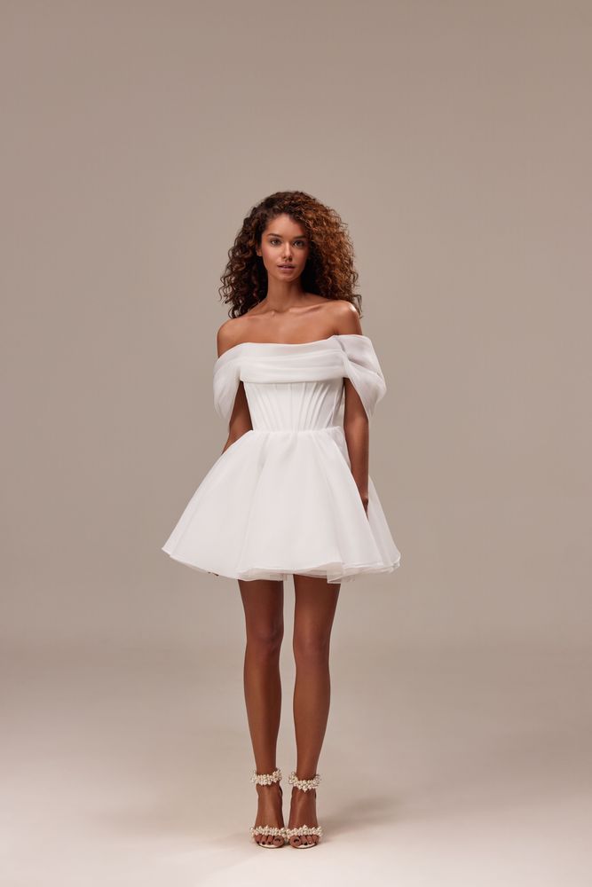 Spectacular off-the-shoulder mini dress cut from flowy organza. Featuring a boned heart-shaped corset with a lace-up closure on the back, and a cute flaring mini skirt.