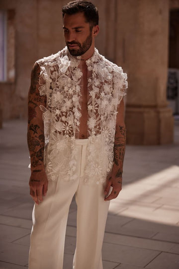 Fashionista wedding set for men. A 2-piece set with a semi-transparent vest covered in floral appliques and classical ivory wide-leg trousers.