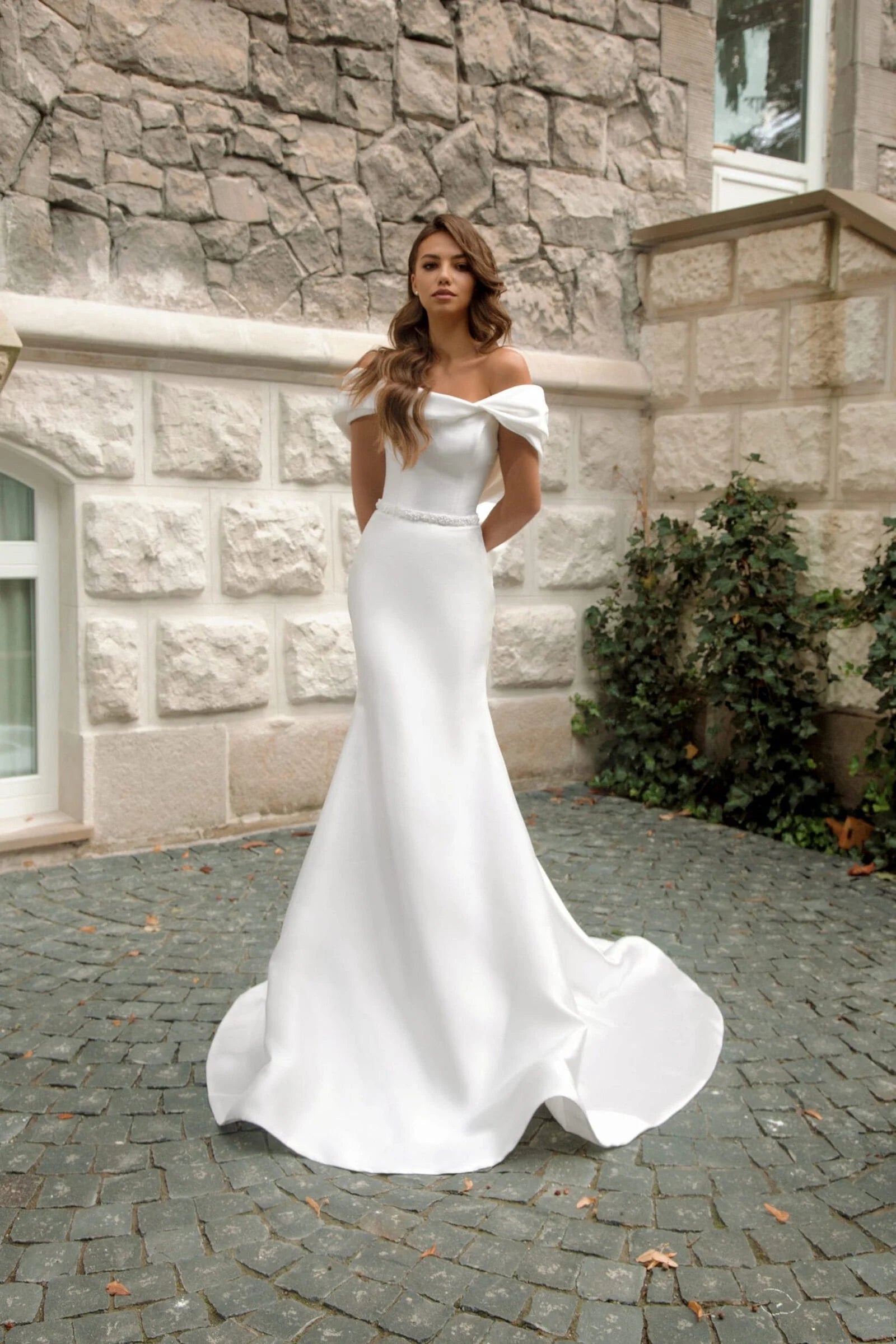 Minimalist Mermaid Wedding Dress with Off-the-Shoulder Sleeves, Boat Neckline, and Band Embellishments for a Chic and Elegant Bridal Look