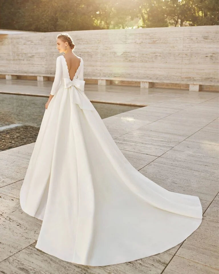 Elegant A-Line Wedding Gown with Exquisite Lace Detailing, Graceful Long Sleeves, a Sophisticated Boat Neckline, and a Flattering Dropped Waist for a Timeless and Regal Bridal Look