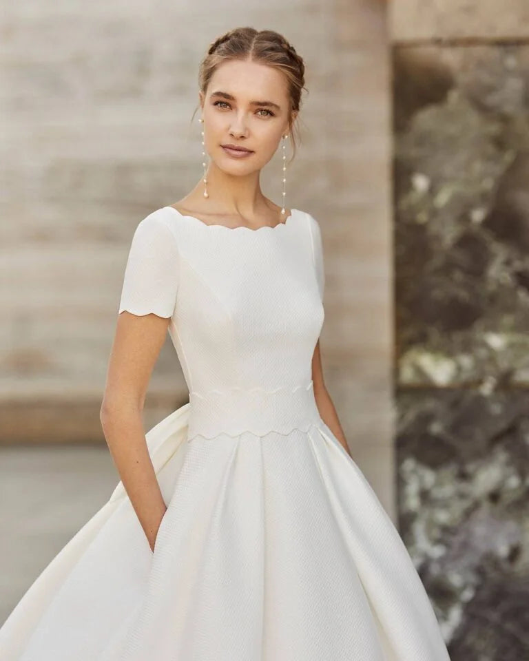 Timeless A-Line Wedding Gown with Exquisite Lace Detailing, Elegant Cap Sleeves, and a Sophisticated Boat Neckline for a Graceful and Romantic Bridal Look