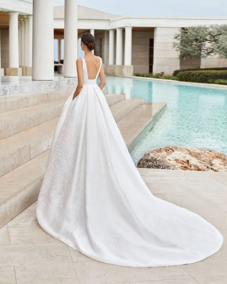 Romantic A-Line Wedding Gown with Delicate Lace Detailing, Elegant Spaghetti Straps, a Flattering V-Neckline, and a Graceful Dropped Waist for a Timeless and Breathtaking Bridal Look