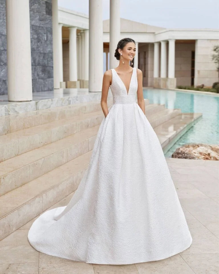 Romantic A-Line Wedding Gown with Delicate Lace Detailing, Elegant Spaghetti Straps, a Flattering V-Neckline, and a Graceful Dropped Waist for a Timeless and Breathtaking Bridal Look