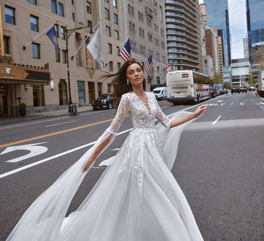 Real fairy gown for a romantic bride. The corset is embroidered with silver sequins and 3D lace and has V-neckline. The decorations proceed to the sleeves, that end with long straps of Tulle.