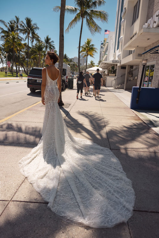 Bloom into a breathtaking bride in this floral lace mermaid wedding dress with a V-neckline and  straps. The exquisite lace embellishments  embrace your figure, flowing into a dramatic train, leaving a lasting impression on your big day.